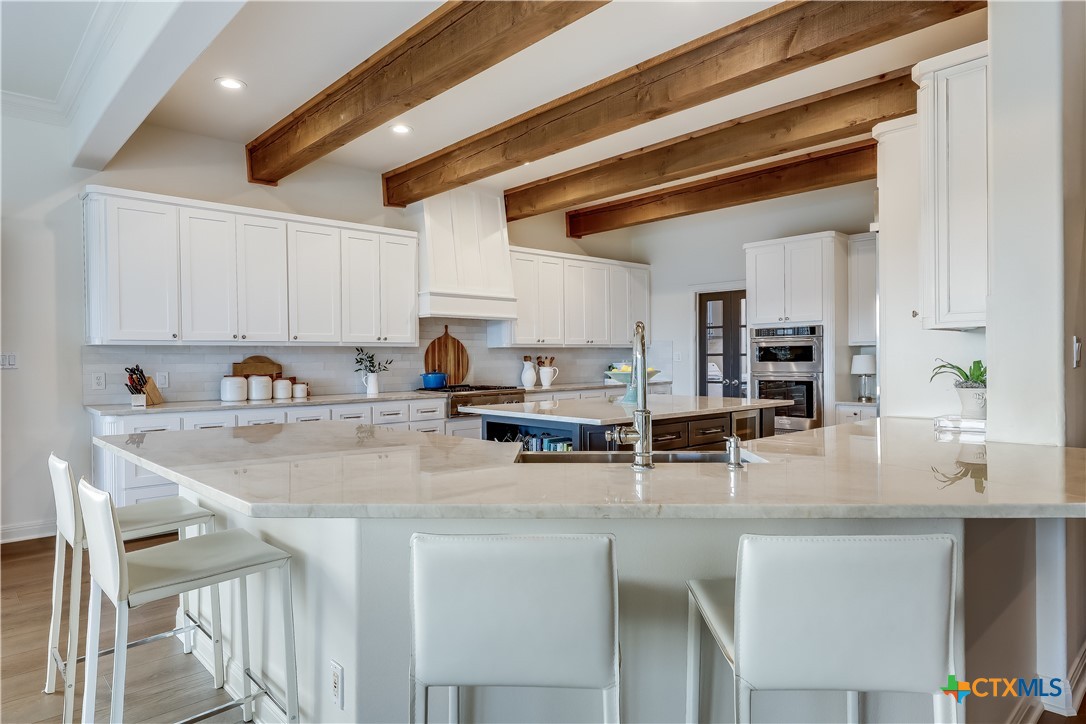 1307 Osprey Ridge Loop Lago Vista, TX 78645 - Photo 9 of 40 a kitchen with stainless steel appliances granite countertop a sink and cabinets