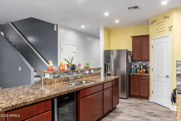 a kitchen with stainless steel appliances granite countertop a refrigerator and a sink