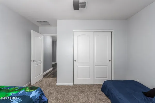 a bedroom with a bed and hallway