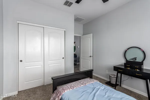 a bedroom with a bed and a table