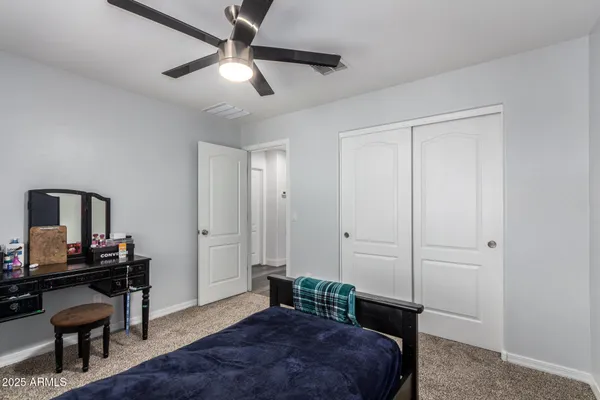 a bedroom with a bed and a desk