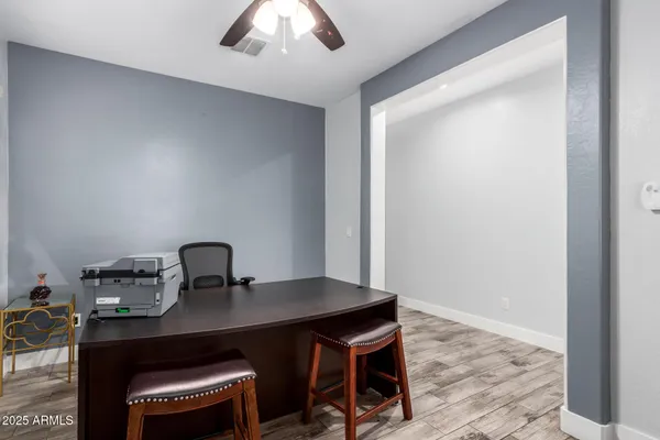 a workspace with a table and chairs
