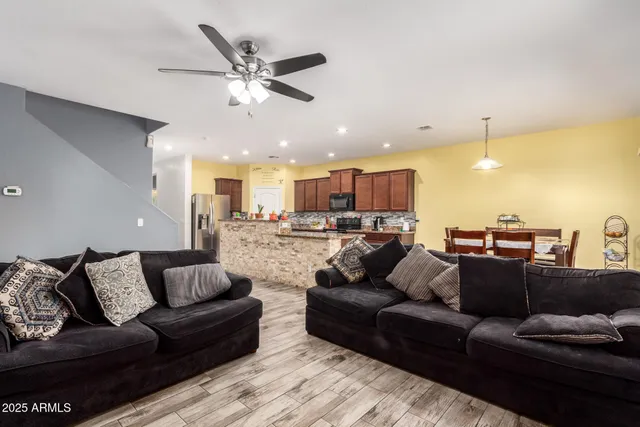 a living room with furniture and kitchen view