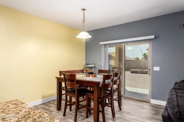 a view of a dining room with a table and chairs
