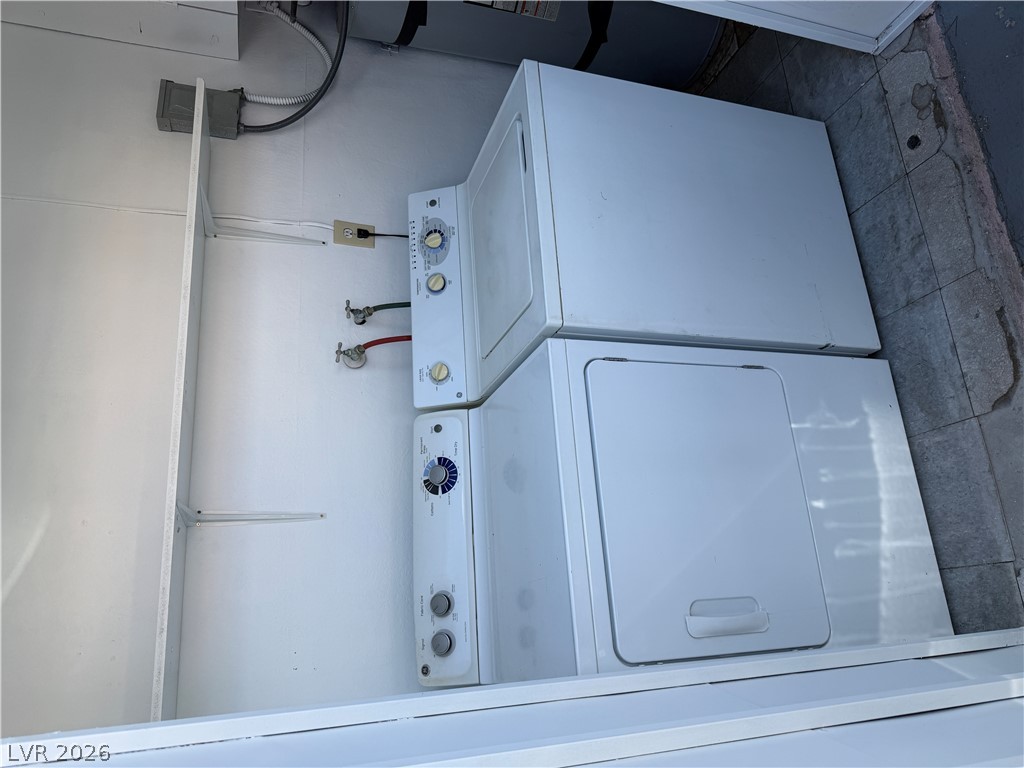 2236 East Desert Inn Road Las Vegas, NV 89169 - Photo 30 of 34 Convenient laundry space features a stacked washer and dryer, ensuring household tasks are effortlessly managed.