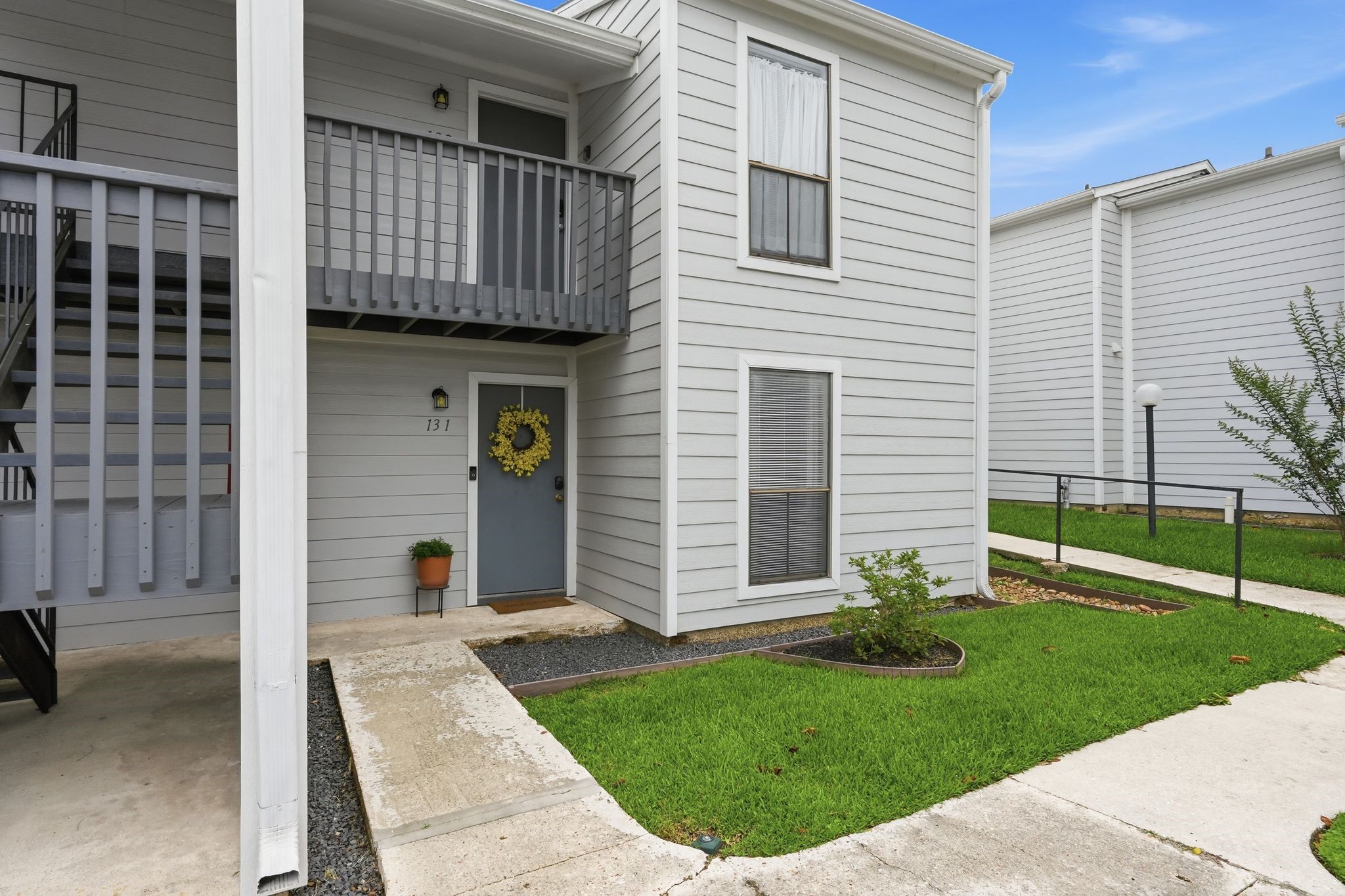 13151 Walden Road, Unit 131 Montgomery, TX 77356 - Photo 32 of 35 Welcoming walkway leading to a private entrance and well-maintained grounds.