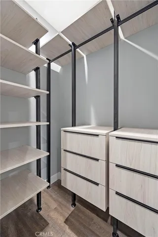 a view of walk in closet with empty racks