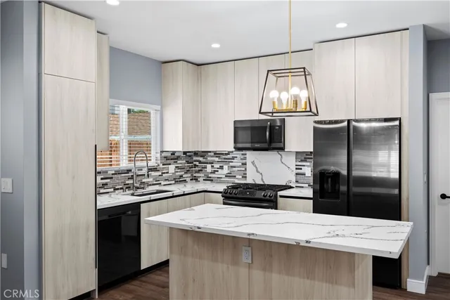 a kitchen with a refrigerator sink and stove
