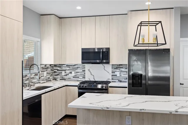 a kitchen with a sink and stainless steel appliances