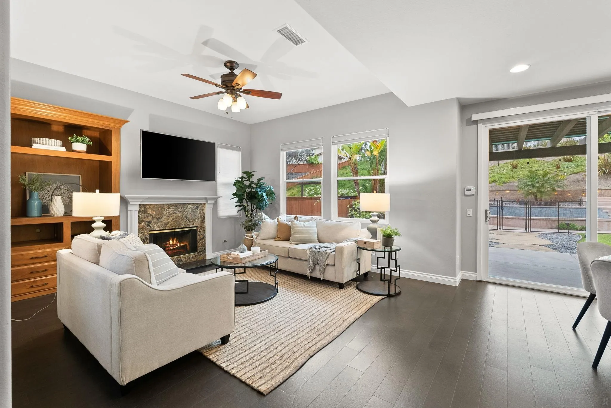 735 River Rock Road Chula Vista, CA 91914 - Photo 11 of 53 a living room with furniture a fireplace and a flat screen tv
