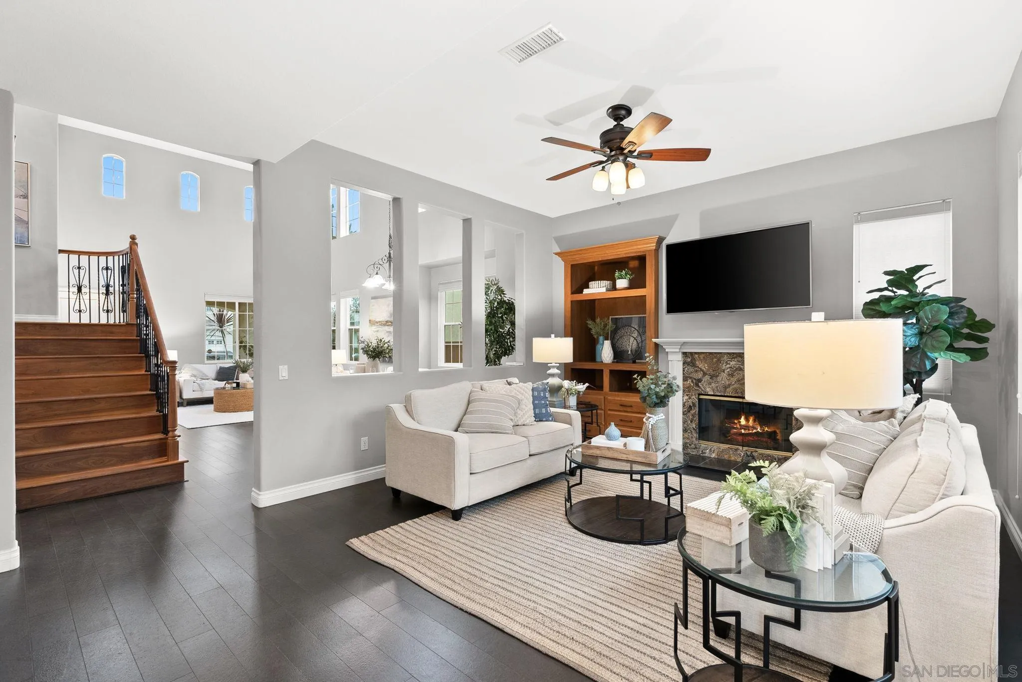 735 River Rock Road Chula Vista, CA 91914 - Photo 12 of 53 a living room with furniture a fireplace and a flat screen tv