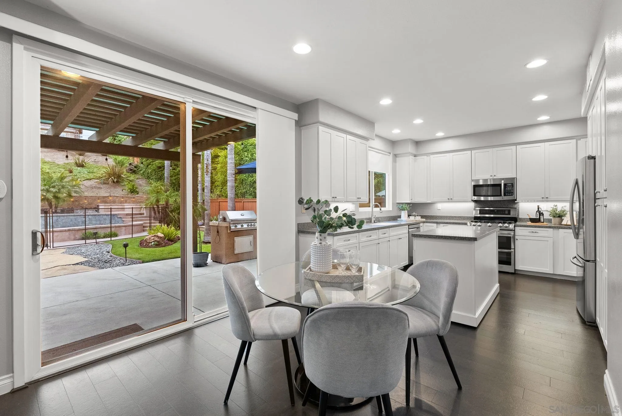 735 River Rock Road Chula Vista, CA 91914 - Photo 14 of 53 a kitchen with a table chairs refrigerator and cabinets