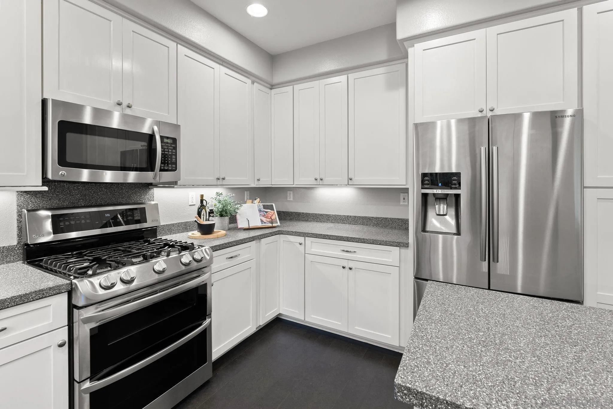 735 River Rock Road Chula Vista, CA 91914 - Photo 18 of 53 a kitchen with stainless steel appliances a refrigerator stove and microwave