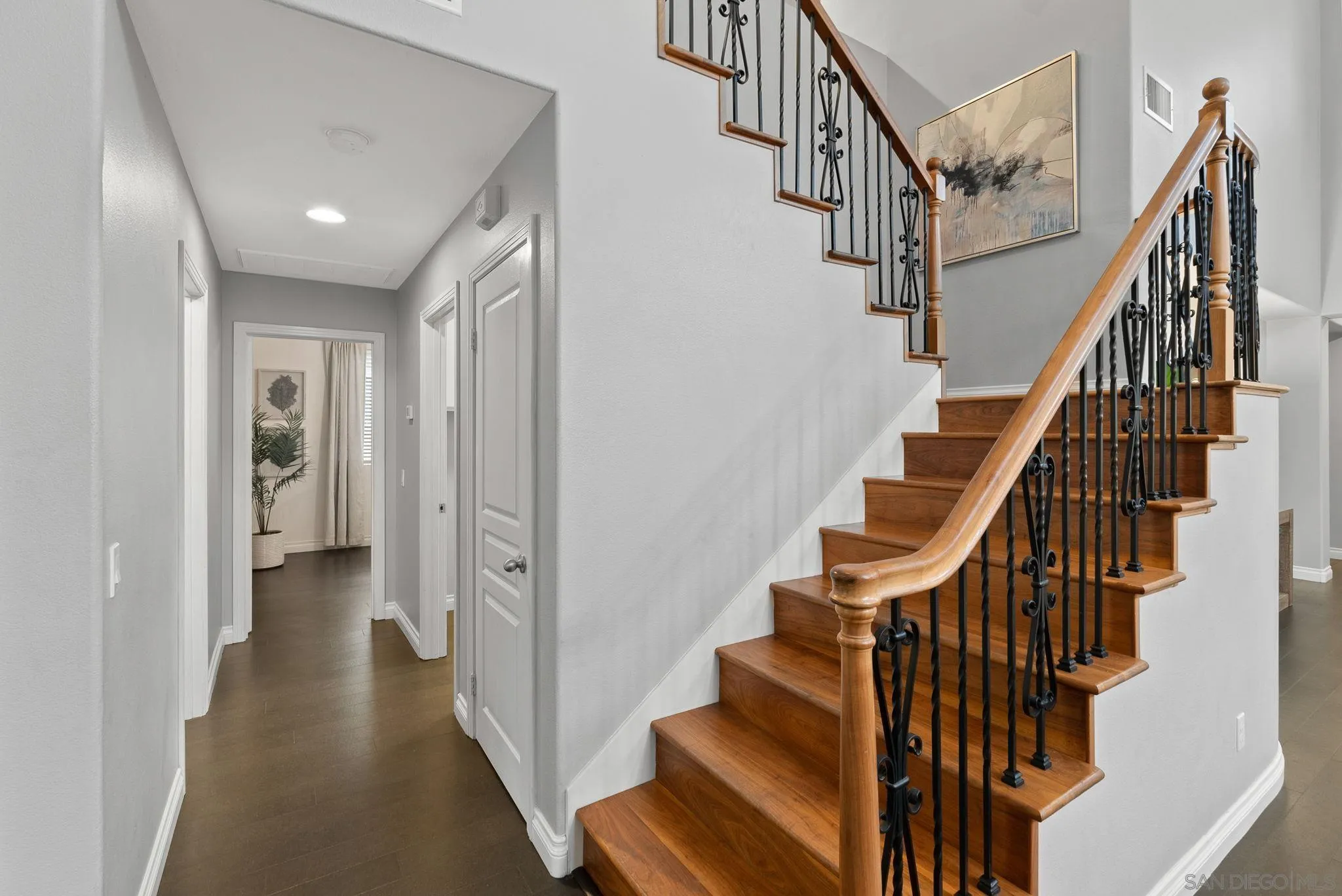 735 River Rock Road Chula Vista, CA 91914 - Photo 19 of 53 a view of staircase with lots of frames on wall and wooden floors