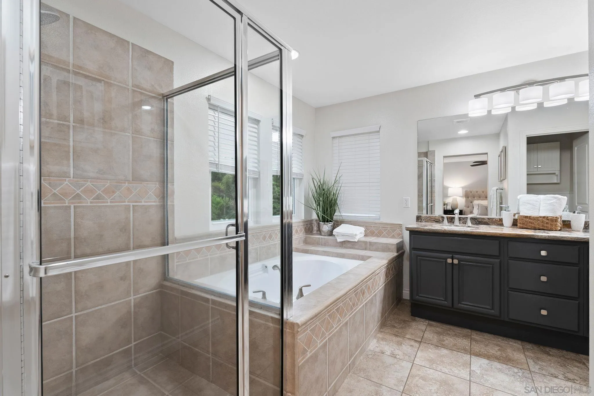 735 River Rock Road Chula Vista, CA 91914 - Photo 22 of 53 a spacious bathroom with a tub sink and mirror