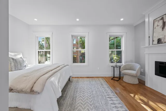 a spacious bedroom with a bed a couch and a window