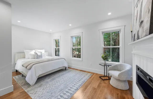 a bathroom with a granite countertop bathtub shower and toilet