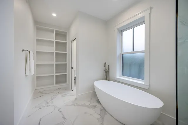 a bed room with a bed and a window