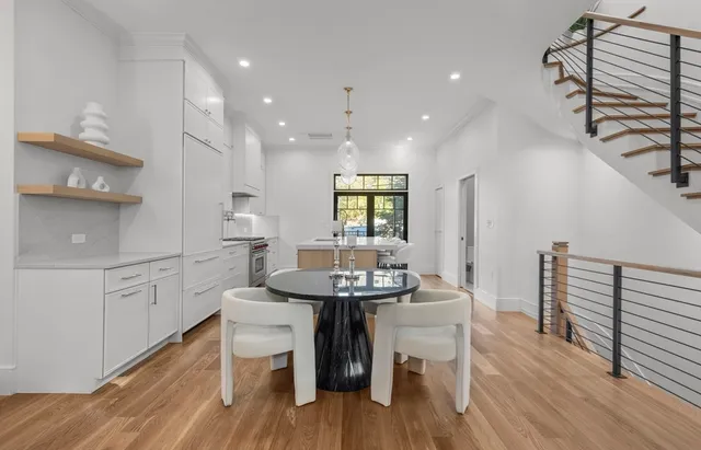 a kitchen with a table chairs sink and cabinets
