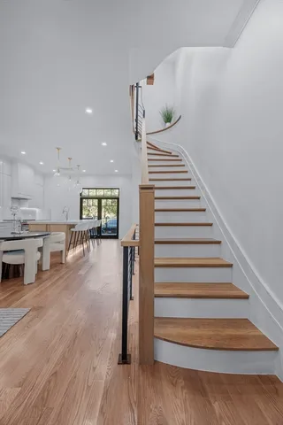 a view of staircase with wooden floor