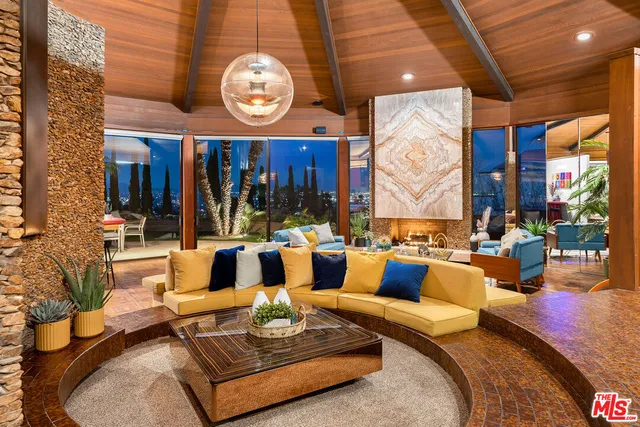 a living room with patio furniture and a large window