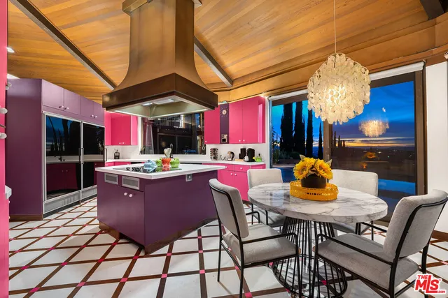 a living room with a table and chairs