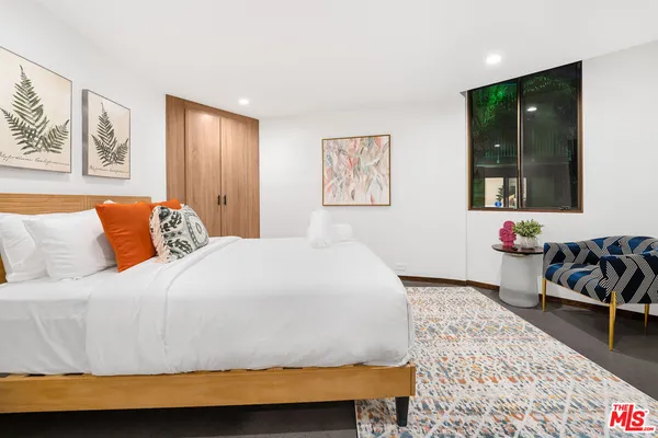 a bedroom with a bed and couch