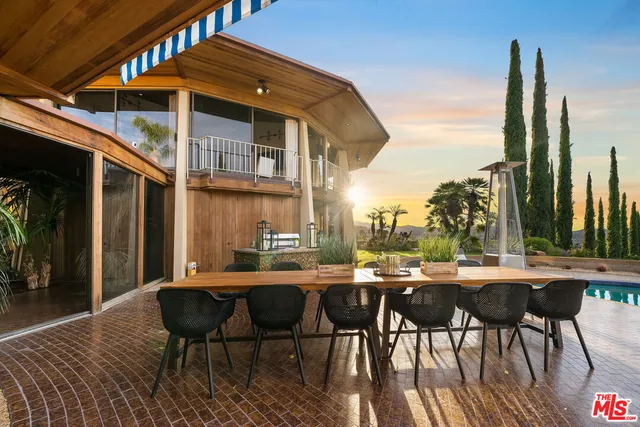 a view of a patio with table and chairs