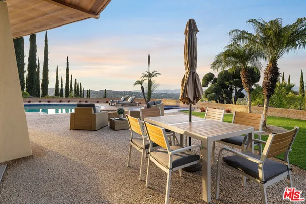 a view of a patio with a table and chairs