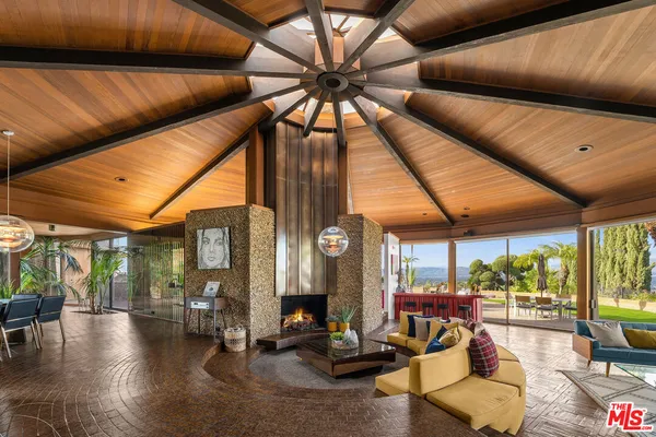 a view of a livingroom with furniture and floor to ceiling window