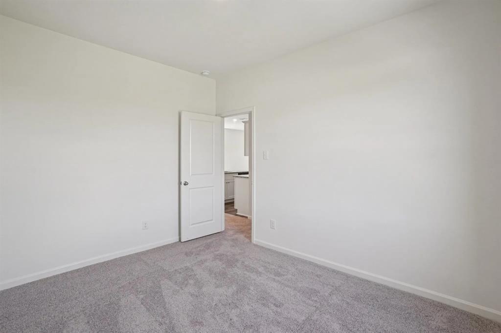4508 Winecup Road Melissa, TX 75454 - Photo 11 of 14 Empty room featuring carpet flooring and baseboards