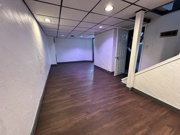 a view of an empty room with wooden floor