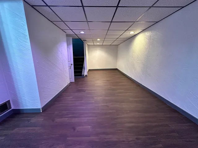 a view of hallway with wooden floor