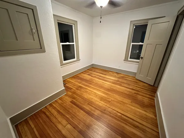 a view of a room with wooden floor and staircase