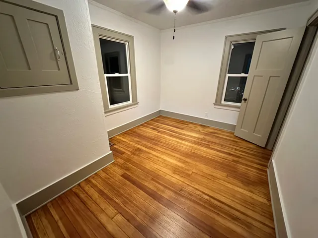 a view of a room with wooden floor and staircase