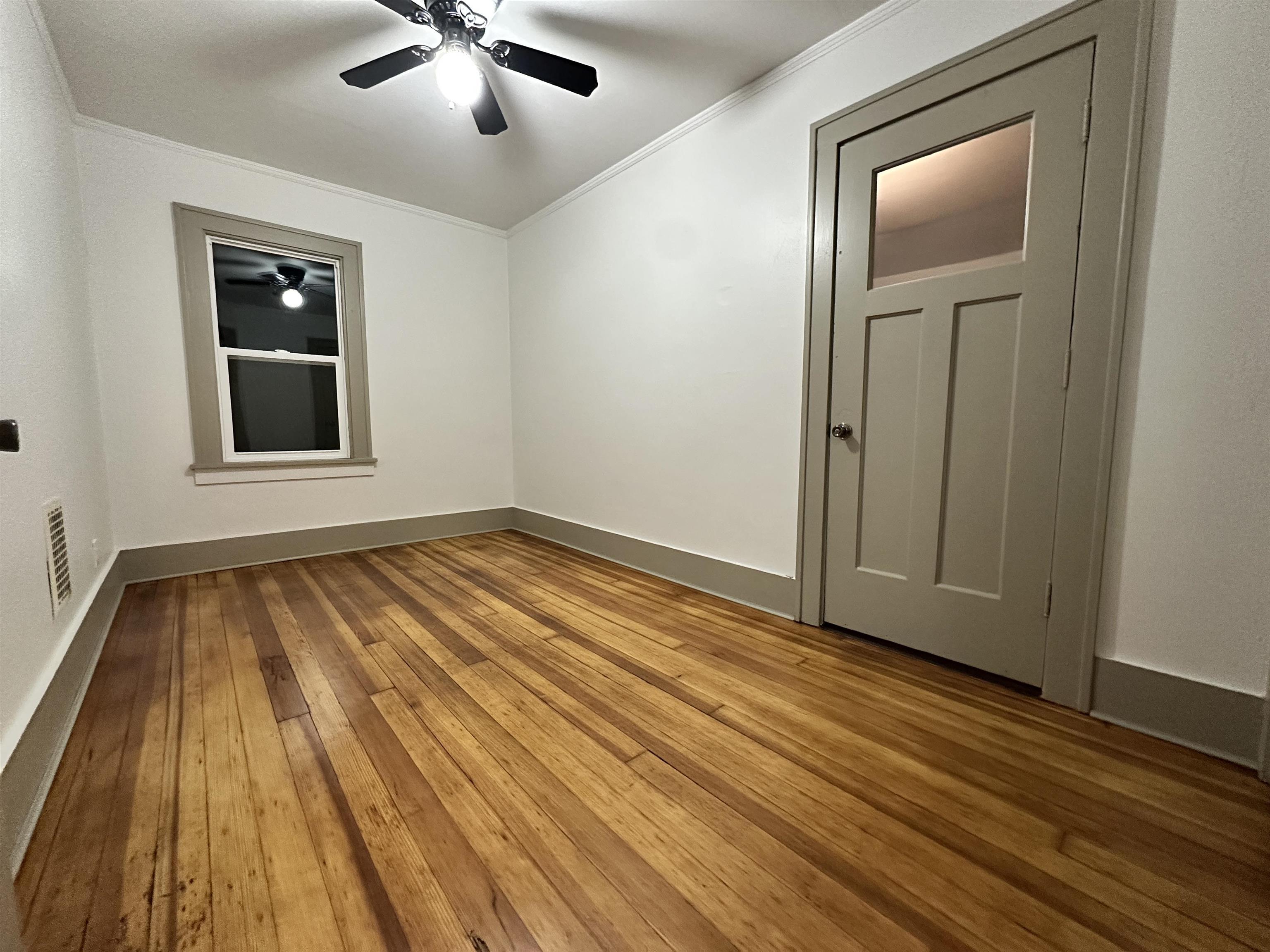 816 South Harlem Avenue Freeport, IL 61032 - Photo 28 of 33 a view of an empty room with wooden floor and a window