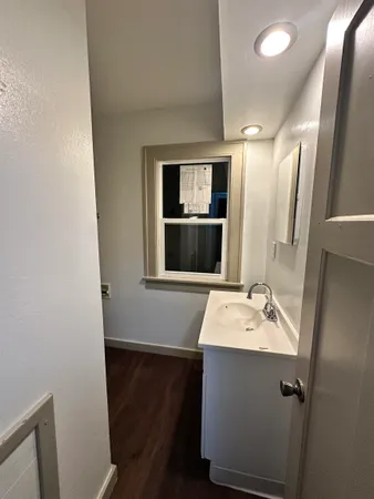 a bathroom with a sink a mirror and vanity