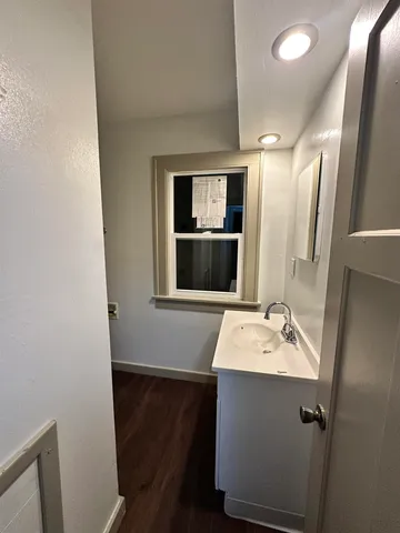a bathroom with a sink a mirror and vanity