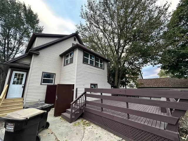 a view of a chairs and tables in the back yard of the house