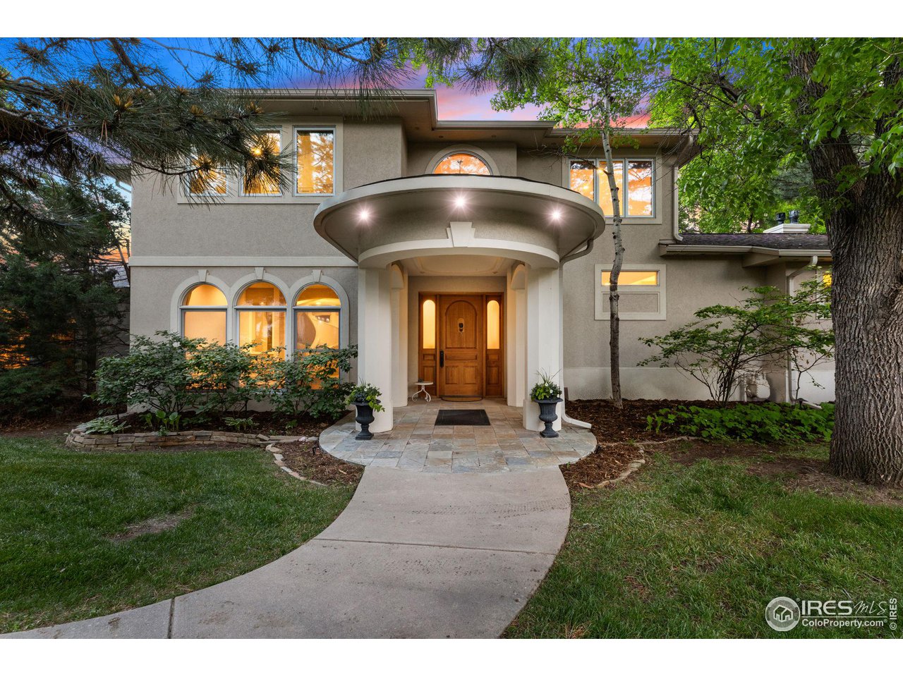 a front view of a house with a garden and patio