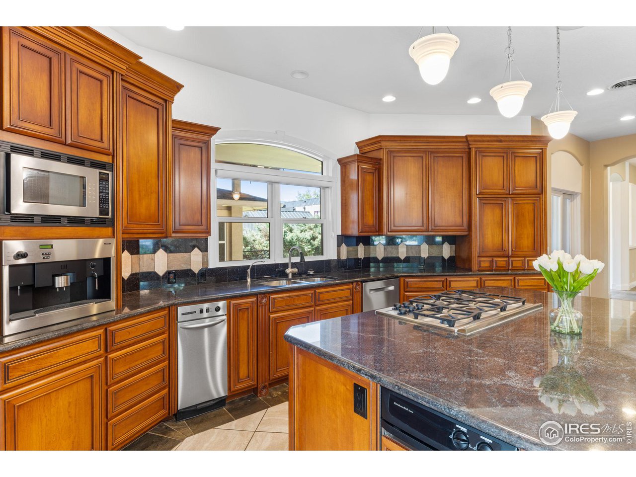 2210 Meadow Avenue Boulder, CO 80304 - Photo 11 of 40 a kitchen with stainless steel appliances granite countertop a sink a stove counter space and cabinets
