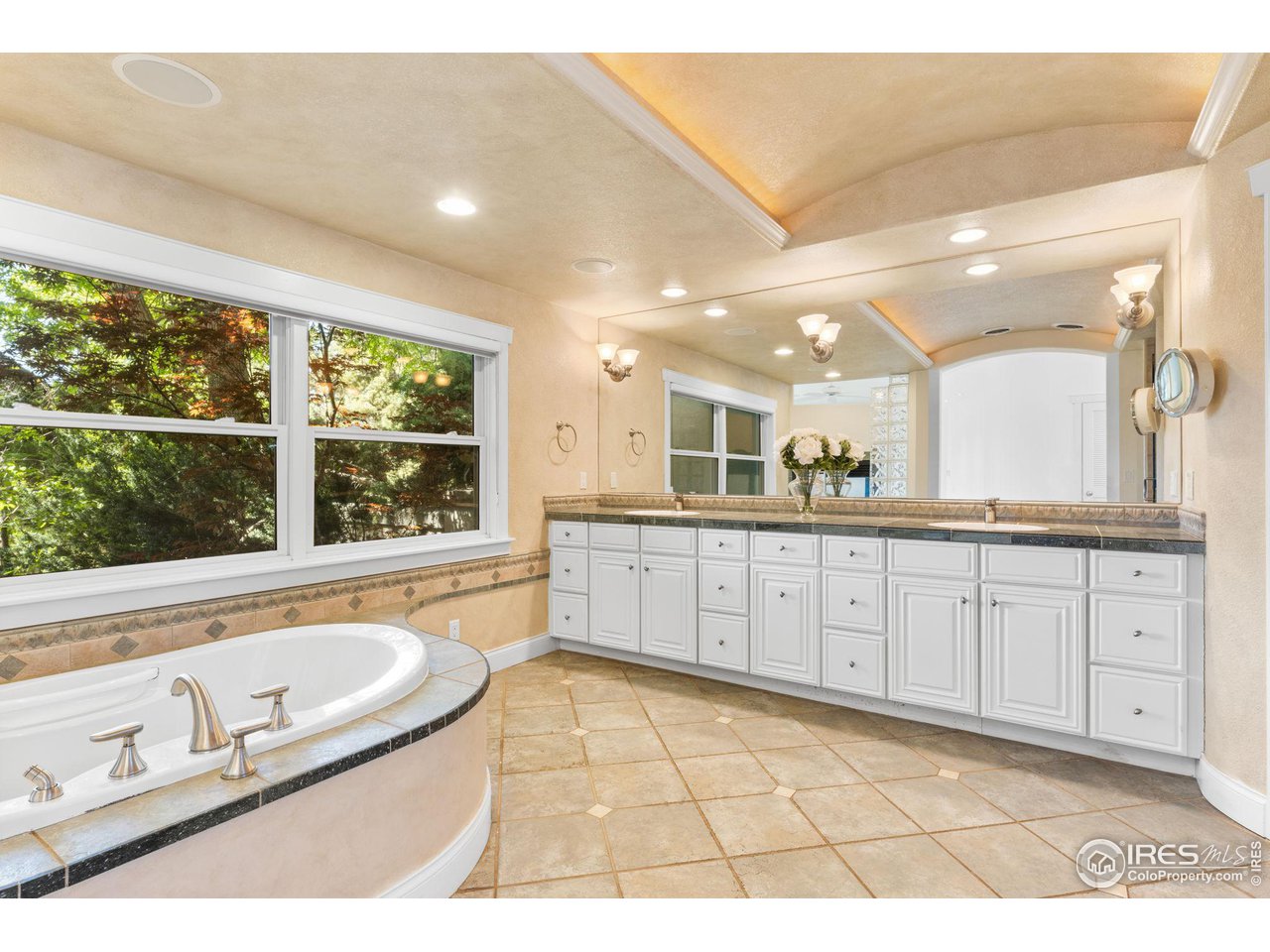 2210 Meadow Avenue Boulder, CO 80304 - Photo 26 of 40 a spacious bathroom with a granite countertop sink and a large mirror