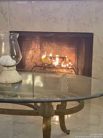 a view of a patio with table and chairs and wooden floor