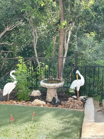 a view of a fountain in the backyard of the house