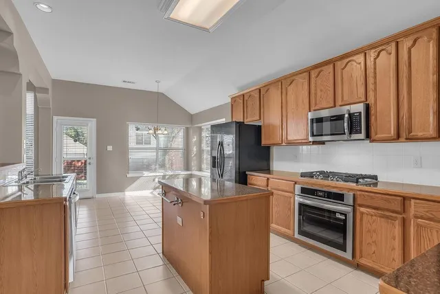 a kitchen with a sink and a refrigerator
