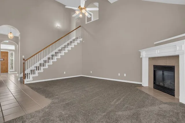 a view of a livingroom with an empty space and a fireplace