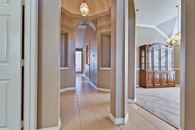 a view of a hallway with wooden floor and dining room