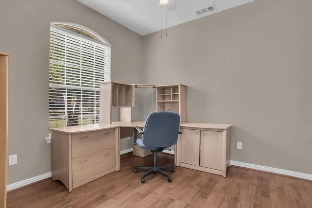 wooden floor in an empty room with a window