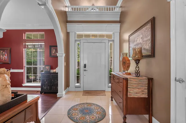 a view of a dining room with furniture a chandelier and wooden floor