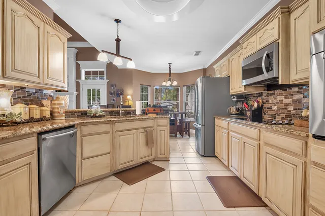 a kitchen with cabinets and window